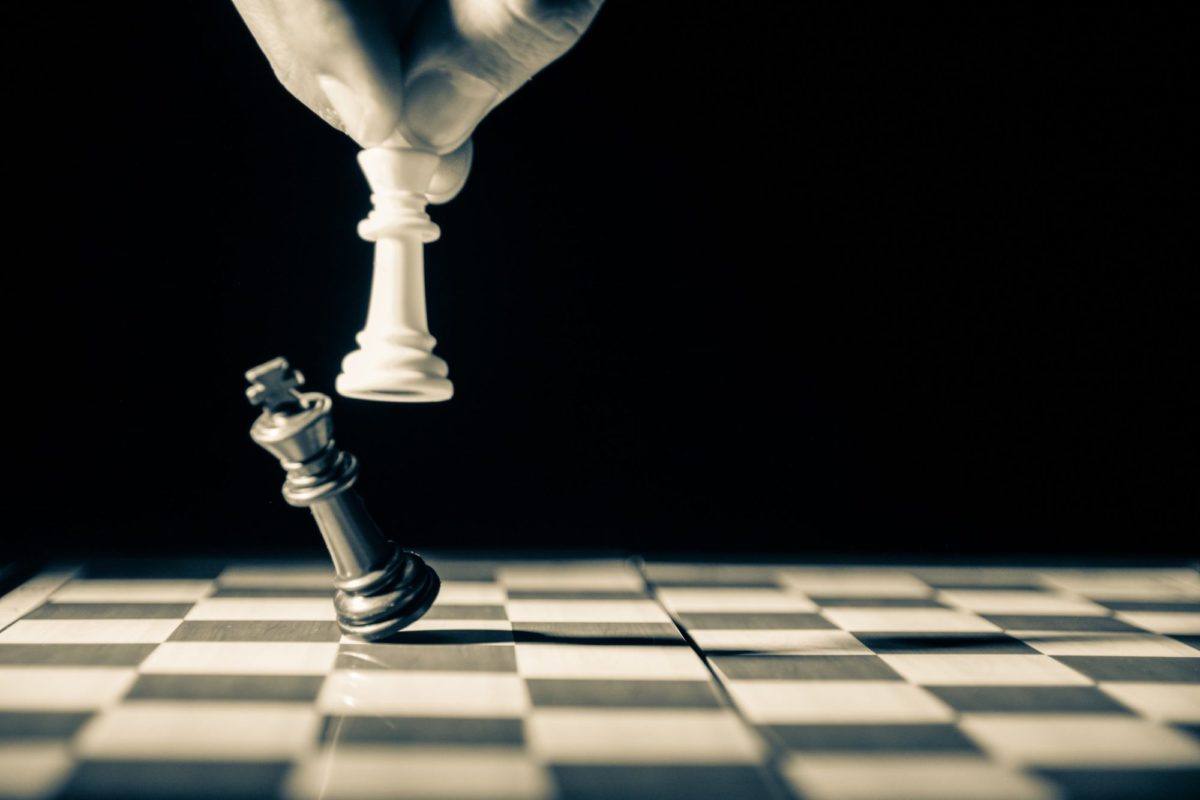 Chess piece king being knocked