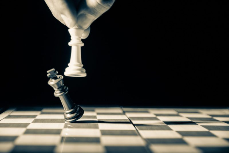 Chess piece king being knocked